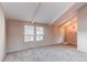 An expansive living room offers tall ceilings with exposed beams, carpet flooring and lots of natural light at 1698 S Kingston St, Aurora, CO 80012