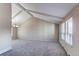 An expansive living room offers tall ceilings with exposed beams, carpet flooring and lots of natural light at 1698 S Kingston St, Aurora, CO 80012