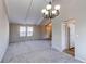 An expansive living room offers tall ceilings with exposed beams, carpet flooring and lots of natural light at 1698 S Kingston St, Aurora, CO 80012