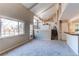 Spacious living room boasts large windows, vaulted ceilings, carpet, and access to other rooms at 1698 S Kingston St, Aurora, CO 80012