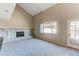 Spacious living room featuring stone fireplace, carpet, and a door leading to the outside at 1698 S Kingston St, Aurora, CO 80012