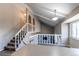 Bright living room featuring vaulted ceilings and a cozy fireplace with white railing to the upper level at 1698 S Kingston St, Aurora, CO 80012