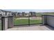 A balcony with an outdoor view of a green field with playground equipment at 16550 Umatilla Pl, Broomfield, CO 80023