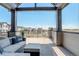 Inviting covered balcony with comfortable seating and views of the neighborhood at 16550 Umatilla Pl, Broomfield, CO 80023