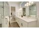 Modern bathroom with double vanity, glass shower, and neutral tile flooring at 16550 Umatilla Pl, Broomfield, CO 80023