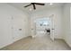 Bright bedroom with white walls, double doors, and a ceiling fan at 16550 Umatilla Pl, Broomfield, CO 80023