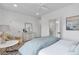 Bright bedroom with cozy armchair, dresser, and en-suite bathroom at 16550 Umatilla Pl, Broomfield, CO 80023