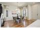 Bright dining room with hardwood floors and a modern chandelier hanging over a round table at 16550 Umatilla Pl, Broomfield, CO 80023