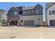 Modern townhome with an attached two-car garage and a well-maintained concrete driveway at 16550 Umatilla Pl, Broomfield, CO 80023