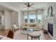 Bright and airy living room featuring a fireplace, large windows, and modern furnishings at 16550 Umatilla Pl, Broomfield, CO 80023