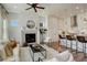 Spacious living room with fireplace open to the kitchen with modern decor and hardwood floors at 16550 Umatilla Pl, Broomfield, CO 80023