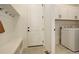 Clean mud room with coat hooks, a bench and a door to the laundry area at 16550 Umatilla Pl, Broomfield, CO 80023