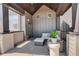 Relaxing covered patio with wicker furniture set, decorative rug, and stylish wooden beams at 16550 Umatilla Pl, Broomfield, CO 80023