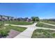 Landscaped playground with grassy lawns, walkway and new construction homes at 16550 Umatilla Pl, Broomfield, CO 80023