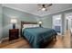 Bedroom features ceiling fan, good natural light, calming color scheme and attached bathroom at 13096 Birch Dr, Thornton, CO 80241