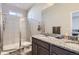 Bathroom with double sink vanity, granite counters, and glass-enclosed shower at 623 S Pitkin Ct, Aurora, CO 80017