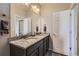 Bathroom featuring granite countertops, double sinks, and a large mirror at 623 S Pitkin Ct, Aurora, CO 80017