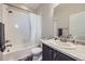 Bathroom with white tiled shower over tub and sink with gray vanity at 623 S Pitkin Ct, Aurora, CO 80017