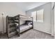 Bedroom featuring a sturdy bunk bed with built-in storage stairs and soft carpet at 623 S Pitkin Ct, Aurora, CO 80017