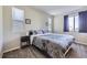 Bedroom features a comfortable bed, neutral decor, and ample natural light at 623 S Pitkin Ct, Aurora, CO 80017