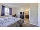 Bedroom with dresser, desk, and ensuite bathroom providing convenience and privacy at 623 S Pitkin Ct, Aurora, CO 80017