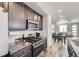 Well-equipped kitchen featuring stainless steel appliances, granite counters, and modern backsplash at 623 S Pitkin Ct, Aurora, CO 80017