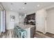 Modern kitchen featuring a large island with seating, stainless steel appliances, and stylish pendant lighting at 623 S Pitkin Ct, Aurora, CO 80017