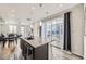 Kitchen island with granite countertop, sink and barstool seating, plus patio access at 623 S Pitkin Ct, Aurora, CO 80017