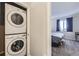 Convenient, stacked washer and dryer near the bedroom at 623 S Pitkin Ct, Aurora, CO 80017