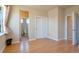 Bedroom with hardwood floors and access to bathroom and hallway at 13699 Pecos Loop, Broomfield, CO 80023