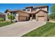 Two-story house with stone accents and a three-car garage at 13699 Pecos Loop, Broomfield, CO 80023