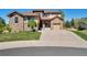 Two-story house with stone accents and a three-car garage at 13699 Pecos Loop, Broomfield, CO 80023