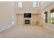 Two-story living room with fireplace and lots of natural light at 13699 Pecos Loop, Broomfield, CO 80023