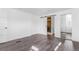 Open bedroom with closet and bathroom access with gray wood look flooring at 801 S Leyden St, Denver, CO 80224