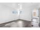 Bright bedroom featuring a view of the yard from dual windows and gray wood look flooring at 801 S Leyden St, Denver, CO 80224
