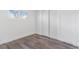 Bright bedroom featuring a large closet with sliding doors and modern wood look flooring at 801 S Leyden St, Denver, CO 80224