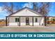 Charming home featuring white siding, black accents, and a welcoming covered porch with classic support columns at 801 S Leyden St, Denver, CO 80224