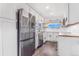 Modern kitchen with stainless steel appliances, sleek white cabinetry, and butcher block countertops for a stylish and functional space at 801 S Leyden St, Denver, CO 80224