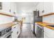 Well-designed kitchen featuring wood countertops, stainless steel appliances, and a seamless transition to the living area at 801 S Leyden St, Denver, CO 80224