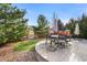 Round patio with seating and playset in backyard at 3087 Black Canyon Way, Castle Rock, CO 80109