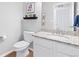 Small bathroom with white vanity, granite countertop, and toilet at 3087 Black Canyon Way, Castle Rock, CO 80109