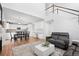 Open concept kitchen and living area with hardwood floors and white cabinets at 3087 Black Canyon Way, Castle Rock, CO 80109