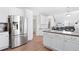 Stainless steel refrigerator in kitchen with white cabinets and granite island at 3087 Black Canyon Way, Castle Rock, CO 80109