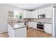 Modern kitchen with white cabinets, granite countertops and stainless steel appliances at 3087 Black Canyon Way, Castle Rock, CO 80109