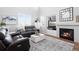 Living room with fireplace, built-in shelving, and high ceilings at 3087 Black Canyon Way, Castle Rock, CO 80109