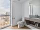 Modern bathroom with a floating vanity and large window at 3575 Chestnut Pl # 406, Denver, CO 80216