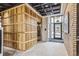 Modern building lobby with elevator and wood wall accents at 3575 Chestnut Pl # 406, Denver, CO 80216