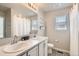 Bright bathroom featuring double vanity, modern fixtures, and stylish black and white patterned flooring at 1353 Reynolds St # 2B, Fort Lupton, CO 80621
