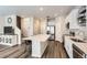 Open-concept kitchen and living space with a large center island and stainless steel appliances at 1353 Reynolds St # 2B, Fort Lupton, CO 80621
