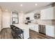 Modern kitchen featuring white cabinets, stainless steel appliances, and a large island with seating at 1353 Reynolds St # 2B, Fort Lupton, CO 80621